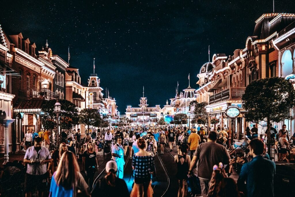 crowd of people outdoors during nighttime at Disneyland Main street